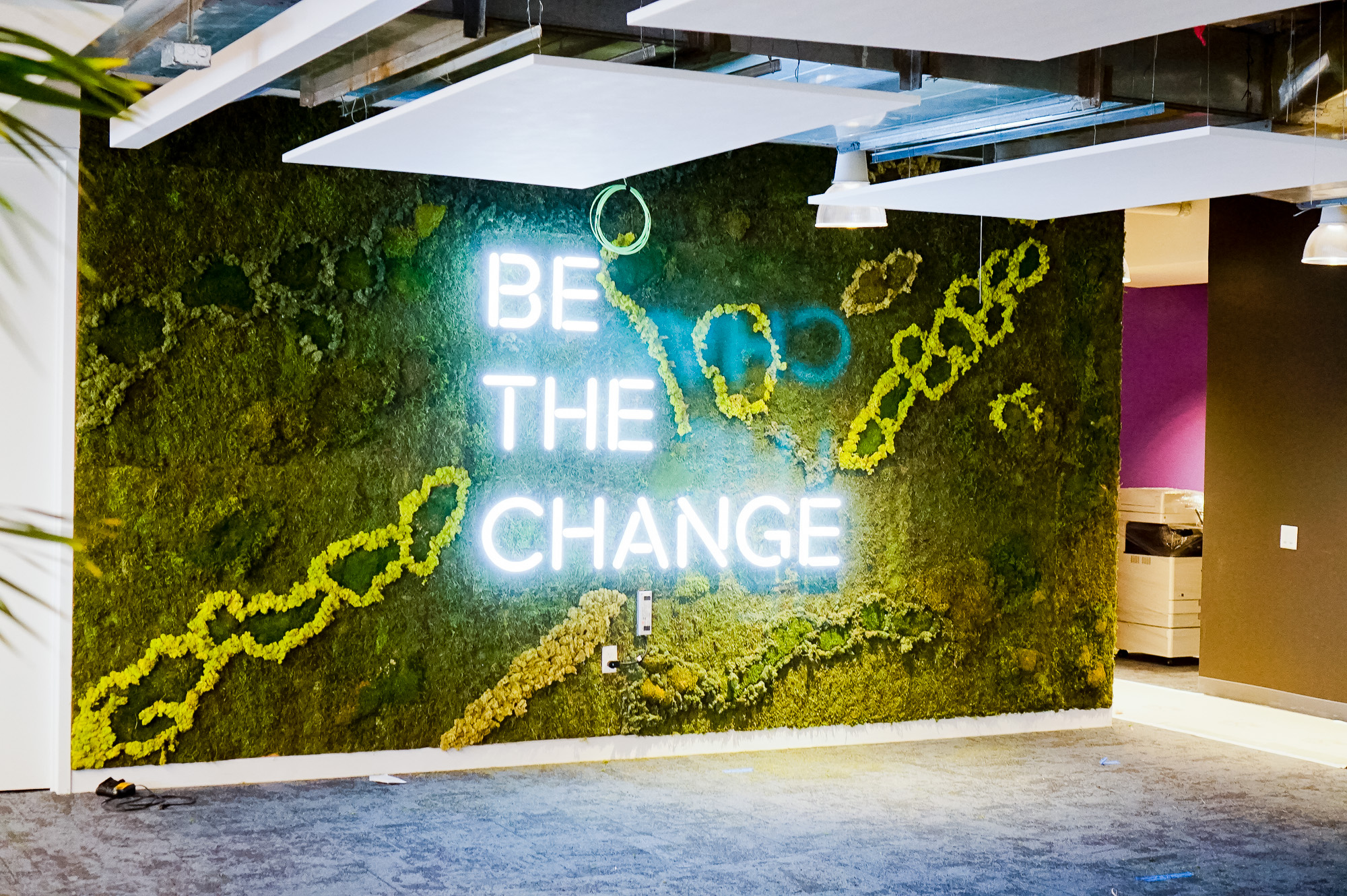 Neon-style, motivational "be the change" sign on a large moss / living wall for Scale, a San Francisco based company delivering high quality training data for AI applications such as self-driving cars, mapping, AR/VR, robotics, and more.