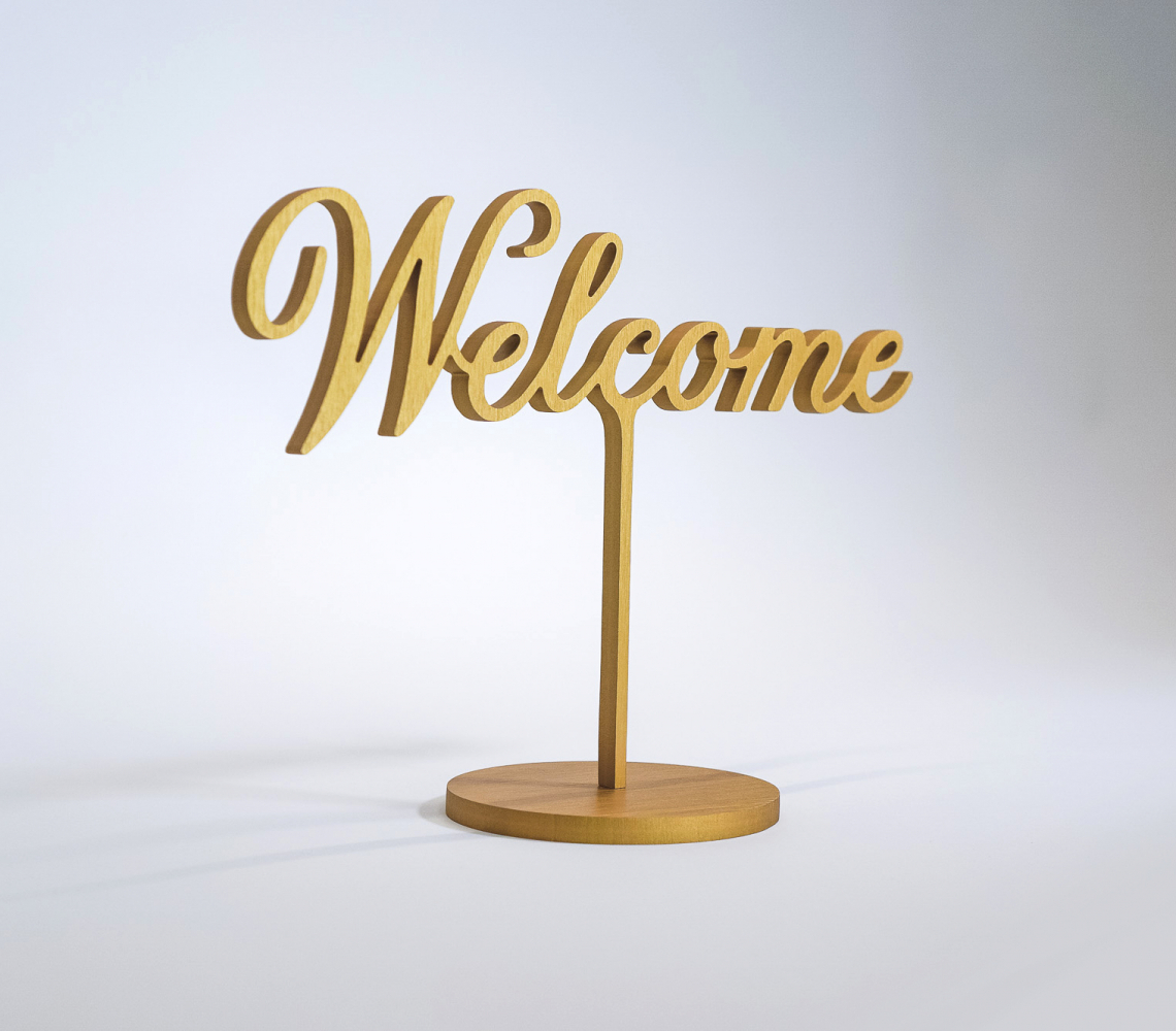 Brushed gold, free-standing welcome sign in script for the entrance at The Wing SF, a co-working space for women.